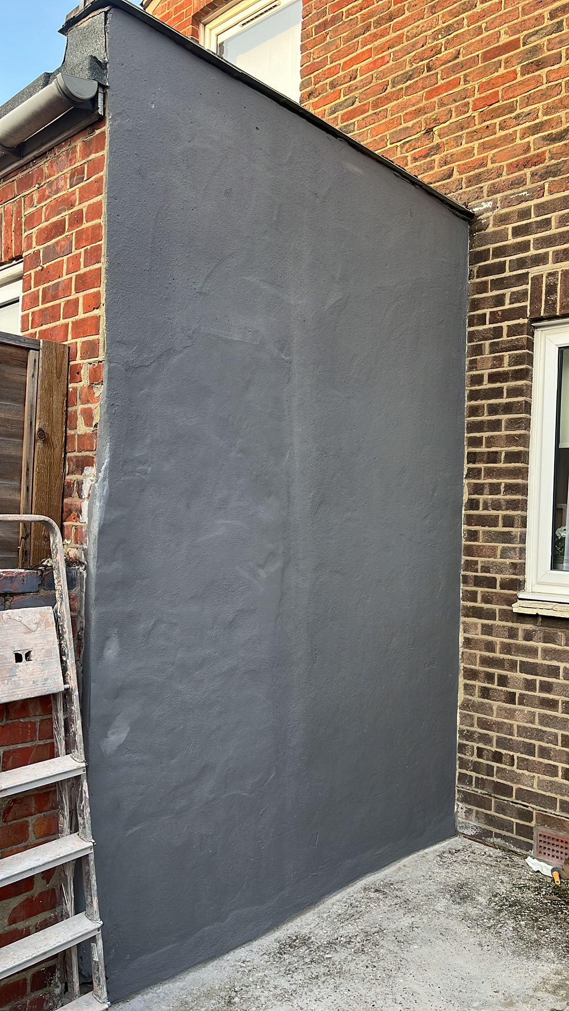 Exterior wall painted dark grey